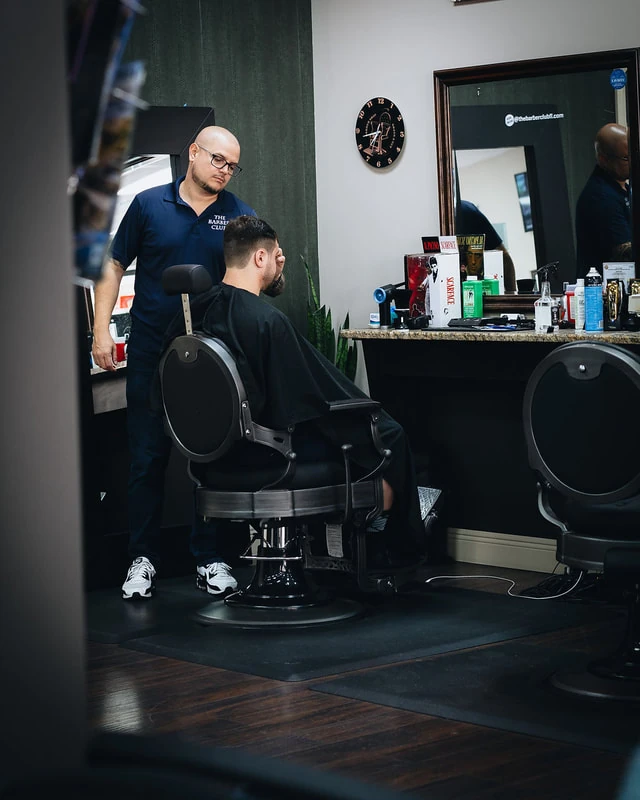 Barber giving a haircut at The Barber Club Pompano Beach